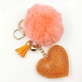 Detail of pink faux fur pompom keychain with orange rhinestone heart charm and gold tassel - Orange Red