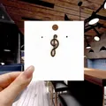 Close-up of G-clef musical note enamel pin badge with gold trim on a white display card - 141*Blue Treble Clef Musical Pin