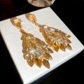 Macro shot of champagne crystal teardrop earrings with gold-plated leafy layer details - Champagne Gold (S925 Silver Pin)