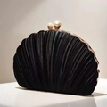 Detailed close-up of shell-shaped evening clutch with pleated texture and pearl clasp - Black