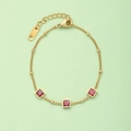 Dettaglio del bracciale in acciaio al titanio dorato con tre pietre preziose rosse - Bracciale di Pietra Quadrata Rossa (N373)