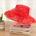 Elegant red organza wide brim sun hat with large bow detail for women on display - One Size / Red