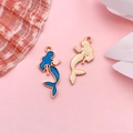 Golden mermaid pendants with blue enamel finish for DIY jewelry making on pink background - Blue Drip Oil Mermaid (13x29mm)