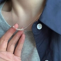 Minimalist silver chain necklace with tiny bead pendants worn over a grey knit sweater - Multi-Ring Beaded Style (XL2782)