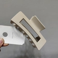 Detail of a large beige square cutout hair claw clip with a Korean minimalist style design - Matte Apricot
