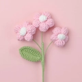 Macro detail of hand-crocheted bouquet featuring three pink puff flowers with green leaves - Light Pink