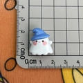 Macro shot showing small white ghost resin charm with blue hat measuring about 2cm - Blue Hat Ghost / Large