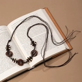 Detail of bohemian handmade woven belt with wooden pendants on a vintage book background - White Coffee Wood Hollow Disc Tassel Belt (X451)