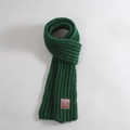 Green knit scarf for children in thick wool yarn featuring a brown leather Keep Move tag - KEEP MOVE Leather Label / Green