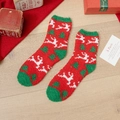 Plush red and green Christmas socks with reindeer and tree patterns on wood background - One Size / White Deer