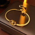 Detailed macro view of 18k gold plated chain bracelet with sparkling zircon inlays - Gold