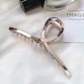Minimalist rose gold metal hair claw clip with twisted line design on white silk - Large Rose Gold