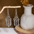 Macro shot of vintage silver bohemian earrings with metal tassels on a rustic branch - E2874-4/Rhombus Hollow Tassel