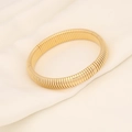 Close-up of golden elastic snake chain bracelet with metallic texture on white silk - Gold-12mm