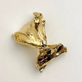 Macro detail of the irregular crinkled texture and golden metallic luster on the spring cuff - Gold