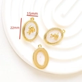 Macro detail of oval gold angel pendant with white shell inlay measuring 15mm by 22mm - 5# Gold Oval Mother Of Pearl Angel Pendant (15x22mm)