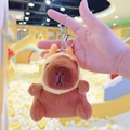 Detailed view of plush capybara keychain featuring yellow antlers and silver metal clasp - Dragon Horn Hat Dark Brown + Silver Clip