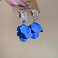 Close-up of blue petal earrings with crystal zircon studs held by hand for display - Silver Pin - Blue - Petal