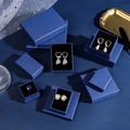 Detailed view of dark blue textured jewelry boxes in various sizes for rings and necklaces - Gentleman Blue