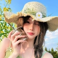 Detail of straw sun hat with green leaves and daisy flower against a blue sky - Beige Daisy Straw Hat (D-529)