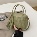 Handmade woven handbag in avocado green leather with decorative side tassels and gold hardware - Green