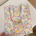 Detail of floral printed canvas tote bag with pink and yellow flowers on white fabric - White Background with Pink Grey Yellow Small Flowers
