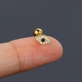Evil Eye gold cartilage stud with double cubic zirconia stones shown on fingertip - Gold (Evil Eye)