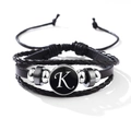 Classic black layered leather bracelet featuring a white letter K charm on a round base - Letter-K