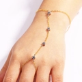 Gros plan d'une bague bracelet en or 18k avec breloques étoiles sur une main - Style Pendentif Étoile à Cinq Branches