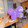 Macro detail of purple butterfly jelly bag with rainbow charms and gold chain strap - Purple