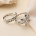 Close-up of 18K gold-plated bow ring set with white zircons and silver rope band - Bowknot + Spiral Pattern Set / Silver