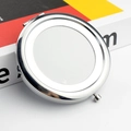 Close-up of a silver metal folding makeup mirror with a blank surface for customization - Hollow Bottom / Silver