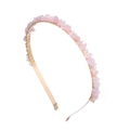 Macro shot of handmade gold wire wrapping around pink natural stones on a hairband - Light Pink