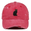 Detail view of distressed cotton baseball cap with embroidered black cat pattern - Watermelon red