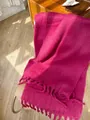 Fuchsia mohair knit scarf with long tassels draped on a chair in warm sunlight - Purplish Red