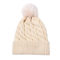 Close-up of beige cable knit beanie featuring thick texture and a fluffy faux fur pompom - Off White