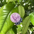 Detail of purple marble acetate hair clip with blue moon and star symbols on green leaves - Purple Star Moon Sphere