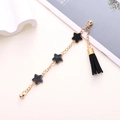 Detail of gold shoe chain with black star charms and tassel on white background - Black Star Tassel Pendant Chain (K353)