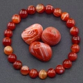 Red stripe agate beaded bracelet with three matching natural raw stones on dark background - Red Stripe Agate