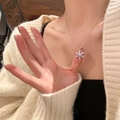 Elegant silver snowflake necklace with a blue gemstone pendant on a thin silver chain - Silver Rotating Snowflake