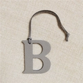 Macro view of grey textured leather letter B keychain accessory on woven background - Letter B Grey