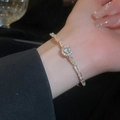 Detailed close-up of a silver zircon bracelet featuring round and baguette-cut stones - Gold Round Geometric
