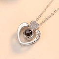 Macro shot of silver heart projection necklace featuring fine zircon stones and central stone - Double Heart White Gold Color