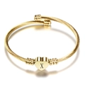 Detail of gold heart pendant with letter X on twisted cable stainless steel bangle - Letter X / Gold