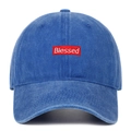 Detail of red box logo with white Blessed embroidery on washed blue baseball cap - Dark Blue