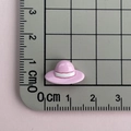 Macro shot of a mini pink resin sun hat accessory measuring 2cm on a scale mat - Pink Hat