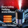 Black cylindrical car aromatherapy diffuser with red starlight projection in a car interior - Plug-in Starry Sky / Fragrans