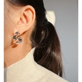 Silver twisted spiral geometric earrings with metallic finish worn by female model - Stud Earrings / Silver