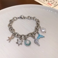 Silver ocean charm bracelet featuring starfish, shells and blue mermaid tail pendants - Silver Starfish Conch Turtle Pendant Bracelet