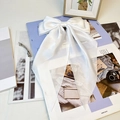 Elegant white satin oversized bow hair clip with long ribbons and a silk-like finish - Pure White